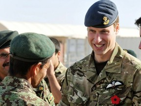 Britain's Prince William talks to a member of the Afghan Army before a remembrance day ceremony on November 14, 2010 at Camp Bastion in southern Afghanistan.