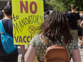 People protest the Ontario government's plan to introduce  vaccine passports, in front of Toronto City Hall on Sept. 1, 2021.