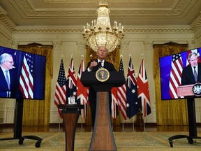 US President Joe Biden participates is a virtual press conference on national security with British Prime Minister Boris Johnson (R) and Australian Prime Minister Scott Morrison in the East Room of the White House in Washington, DC, on September 15, 2021.