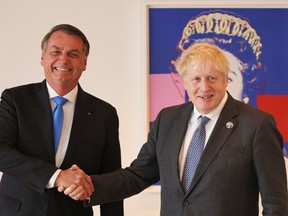 Brazil’s president Jair Bolsonaro and British Prime Minister Boris Johnson shake hands as they prepare to have a bilateral meeting at the UK diplomatic residence on September 20, 2021 in New York City.