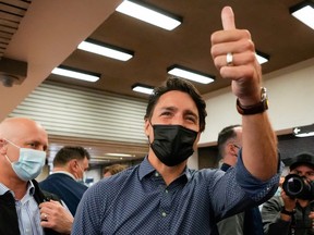 Canada's Liberal Prime Minister Justin Trudeau gestures as he greets supporters, after the Liberals won a minority government, at the Jarry Metro station in Montreal, Quebec, Canada, September 21, 2021.