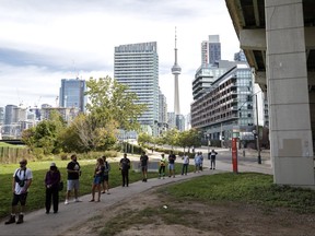 Voters wait in line outside a polling station in downtown Toronto today.