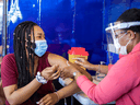 A healthcare worker administers a Pfizer COVID-19 vaccine at a pop up clinic in Brampton, Ontario.