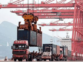 A crane loads a container onto a truck at Lianyungang Port in China on September 7, 2021.