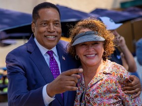 Republican gubernatorial candidate Larry Elder greets a supporter as he makes a campaign stop outside a restaurant in San Diego, California, U.S. Sept. 3.
