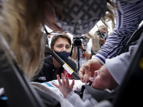 Liberal Leader Justin Trudeau looks at a one-month-old baby as he walks on St-Laurent boulevard during the Canadian federal election campaign in Montreal, Que., on Thursday, September 2, 2021.