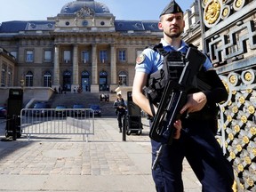 French police guard the Paris courthouse on the Ile de la Cité ahead of the opening of the trial.