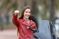 Happy motorcycle buyer showing keys at camera outdoor