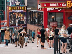 People walk in the tourist areas of Niagara Falls, Ont., after COVID-19 restrictions were loosened, July 16, 2021.