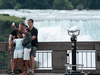 Tourists pose for photos in Niagara Falls, Ont. The city, which relies heavily on tourism, has had a difficult time over the last 18 months due to lockdowns and COVID-19.