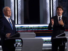 Liberal leader Justin Trudeau gestures toward Conservative Leader Erin O'Toole during a French-language leaders' debate at the Canadian Museum of History in Gatineau, Que., on Sept. 8, 2021.