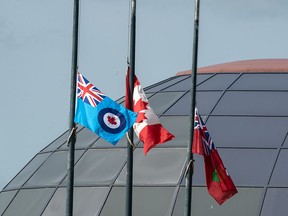 Flags fly at half-mast at the Canadian Warplane Heritage Museum in Hamilton, Ont., on Sept. 13, 2021, as federal facilities continue to keep their flags lowered out of respect for those who died while at Indigenous residential schools.
