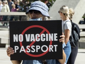 People protest the implementation of the QR Code Covid 19 vaccine passport by the Ontario Provincial Government out front of Toronto City Hall during the Covid 19 pandemic, Wednesday September 1, 2021.