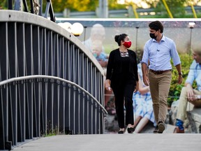Justin Trudeau walks with Liberal candidate Maryam Monsef during a campaign stop in Peterborough, Ont., on Sept. 18, 2021. Monsef is projected to lose the riding to Conservative candidate Michelle Ferreri.