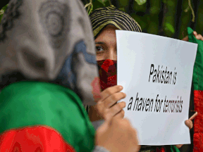 An Afghan national residing in India takes part in a protest against Pakistan in New Delhi on Nov. 10, 2012.