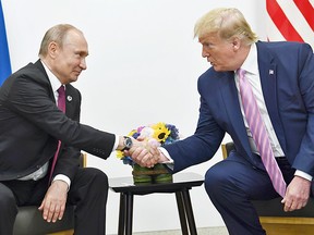 Then the U.S. president, Donald Trump speaks  with Russia's President Vladimir Putin during the G20 summit in Osaka on June 28, 2019.