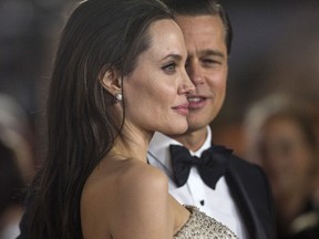 Director and cast member Angelina Jolie and her husband and co-star Brad Pitt pose at the premiere of 'By the Sea' in Hollywood, Calif. in 2015.