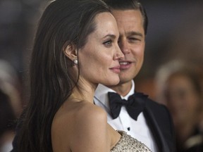 Director  Angelina Jolie and her then husband and co-star Brad Pitt pose at the premiere of 'By the Sea' in Hollywood, Calif. in 2015.