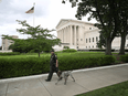 A U.S. Capitol Police Officer walks with a dog near the U.S. Supreme Court in Washington, following an abortion ruling by the Texas legislature, September 1, 2021.