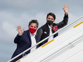 Liberal Leader Justin Trudeau boards his campaign plane with Dominic Leblanc, Liberal candidate and Trudeau's minister of intergovernmental affairs, in Halifax on Sept. 15, 2021.