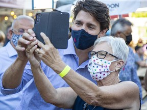 Liberal Leader Justin Trudeau has a photo taken with a supporter during a campaign stop in London, Ont., on Sept. 6, 2021.