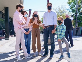 Liberal leader Justin Trudeau waits in line to cast his ballot in the 44th general federal election as he's joined by wife Sophie Gregoire-Trudeau, and children, Xavier, Ella-Grace and Hadrien in his riding of Papineau, Montreal on Monday, Sept. 20, 2021.