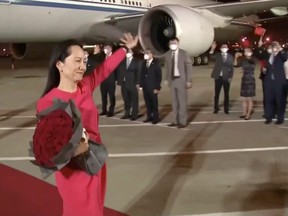 Huawei Technologies Chief Financial Officer Meng Wanzhou waves upon arriving from Canada at Shenzhen Baoan International Airport, in Shenzhen, Guangdong province, China on Sept. 25, 2021.