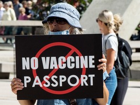 People protest the implementation of COVID-19 vaccine certificates by the Ontario government, in front of Toronto City Hall on Sept. 1, 2021.