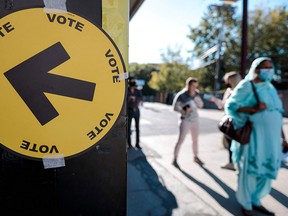 Voters line up to cast their ballots in Montreal in the federal election on Sept. 20, 2021.