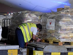 A worker prepares to load a shipment of humanitarian aid to be sent to Afghanistan at Bahrain International Airport on Muharraq Island, near the capital Manama, on September 4, 2021.