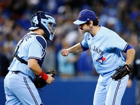 Jordan Romano #68 of the Toronto Blue Jays celebrates the win with catcher Reese McGuire #7 against the New York Yankees at Rogers Centre on September 29, 2021 in Toronto, Ontario, Canada.