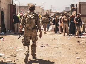 A Canadian coalition forces member walks through an Evacuation Control Checkpoint (ECC) during an evacuation at Hamid Karzai International Airport in Kabul, Afghanistan on Aug. 24, 2021.