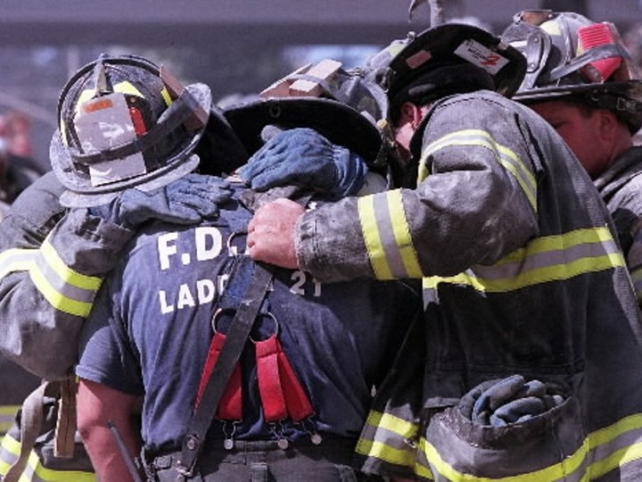  Firefighters grieve for their colleagues following the collapse of the World Trade Center towers, Tuesday.