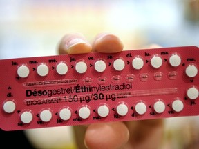 In this file photo taken on January 2, 2013 a person shows third-generation contraceptive pills in a pharmacy in Lille, in northern France.