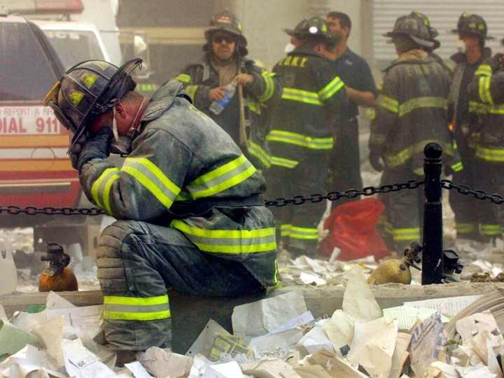 Firefighter Gerard McGibbon, of Engine 283 in Brownsville, Brooklyn, prays after the World Trade Center buildings collapsed September 11, 2001 after two hijacked airplanes slammed into the twin towers in a terrorist attack that killed some 3,000 people.