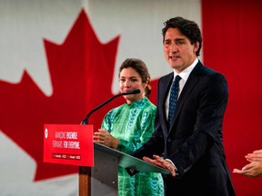 Canadian Prime Minister Justin Trudeau, flanked by wife Sophie Gregoire-Trudeau, delivers his victory speech after general elections at the Queen Elizabeth Hotel in Montreal, Quebec, early on September 21, 2021.