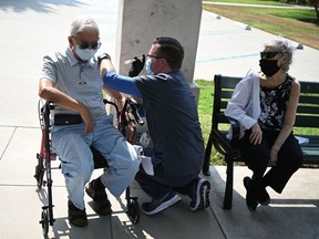 Nurse Kevin Grellman administers a third booster dose of Pfizer Covid-19 vaccine to Jose Gomez, 80, after his wife Armida Gomez, 81, received hers during a vaccination clinic hosted by Tournament of Roses and the Pasadena Department of Public Health on August 19, 2021 at Tournament House in Pasadena, California.