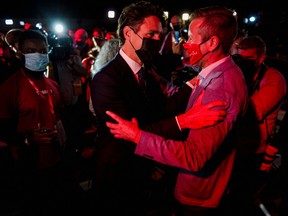 Prime Minister Justin Trudeau greets supporters as he leaves the Fairmount Queen Elizabeth Hotel after delivering his victory speech in Montreal on Tuesday morning.