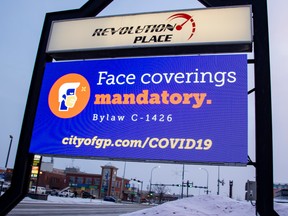 A sign advising people of the mandatory use of face masks in public places is seen in Grande Prairie, Alta.