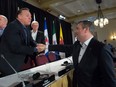 Alberta Premier Jason Kenney, right, shakes hands with Quebec Premier Francois Legault during a meeting of Canada's premiers in Saskatoon in 2019.