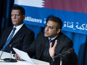 Mohamed Fahmy, right, a former Al Jazeera English reporter, speaks during a press conference at the U.S. National Press Club in 2017 about a lawsuit against Qatar's Al Jazeera in Washington, D.C.