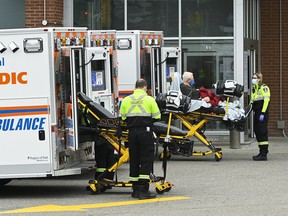 Paramedics transport an elderly man to the hospitals emergency department during the COVID-19 pandemic in Mississauga, Ont., in Nov., 2020.