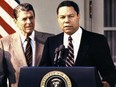 Colin Powell, right, speaks at the White House after U.S. President Ronald Reagan, left, announced Powell's promotion to national security advisor, in 1987.