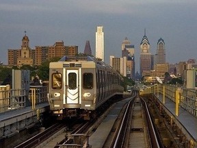 A SEPTA train on the Market-Frankford rapid transit line with the Philadelphia skyline in the background.