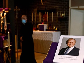 A photograph of Conservative British lawmaker David Amess, who was fatally stabbed, is pictured prior to a service at Belfairs Methodist Church in Leigh-on-Sea, a district of Southend-on-Sea, in southeast England on Oct. 15, 2021.