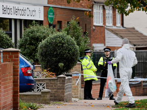 In this Saturday photo, police and forensics officers work at the scene of the fatal stabbing of Conservative British lawmaker David Amess. It was the second public murder of a sitting British MP in the last five years.