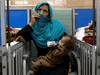 A woman holds her one-year-old baby in the malnutrition ward for infants at the Indira Gandhi hospital in Kabul, October 23, 2021.