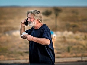 Alec Baldwin speaks on the phone in the parking lot outside the Santa Fe County Sheriff's Office in Santa Fe, N.M., after he was questioned about a shooting on the set of the film Rust on the outskirts of Santa Fe, Oct. 21, 2021.