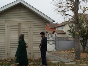 Azatullah and Mastora, both Afghan refugees, arrived in Canada with 11 other relatives in August. They stand in the backyard of their new home in Calgary's north-east. October 13, 2021 (Bryony Lau photo)
