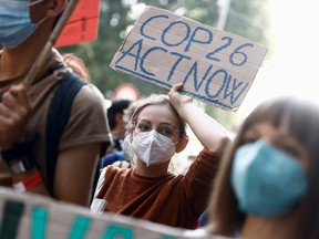 People take part in the 'Global march for climate justice' while environment ministers meet ahead of Glasgow's COP26 meeting, in Milan, Italy, October 2, 2021